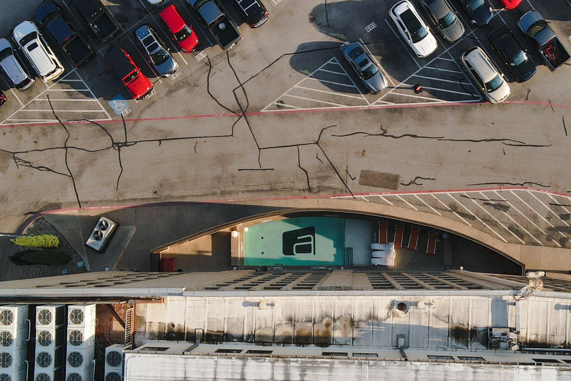 While the Aloft Downtown Dallas' pool is literally located adjacent to the parking lot, the clever design makes it feel private.